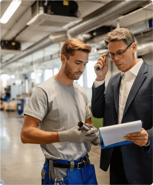 Engineers analyzing reports on a factory floor